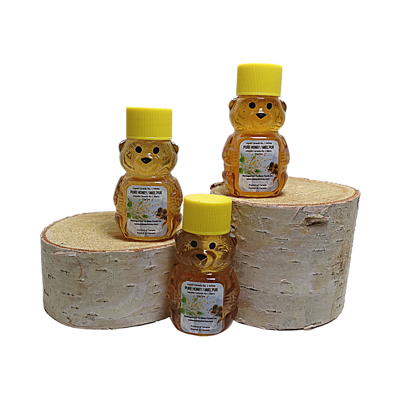 Three 2 oz miniature bear honey containers with yellow lids on a white background