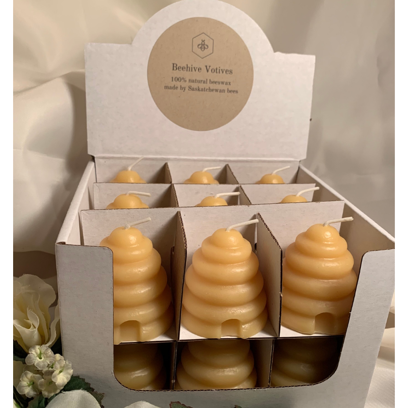 18 Beeswax beehive shaped votives in a cardboard display. Handmade and poured in small batches. 100% Canadian made.