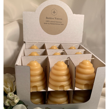 18 Beeswax beehive shaped votives in a cardboard display.  Handmade and poured in small batches. 100% Canadian made.