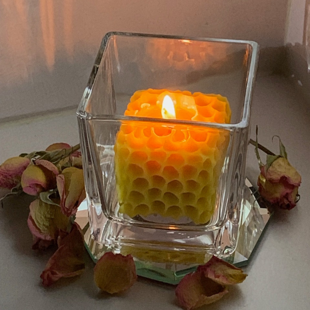 Honeycomb votive in a square glass holder.  100% Beeswax votive in the shape of a piece of honeycomb