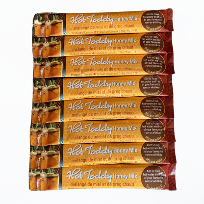 Eight Tu-Bees Hot Toddy Honey Mix packages on a white background