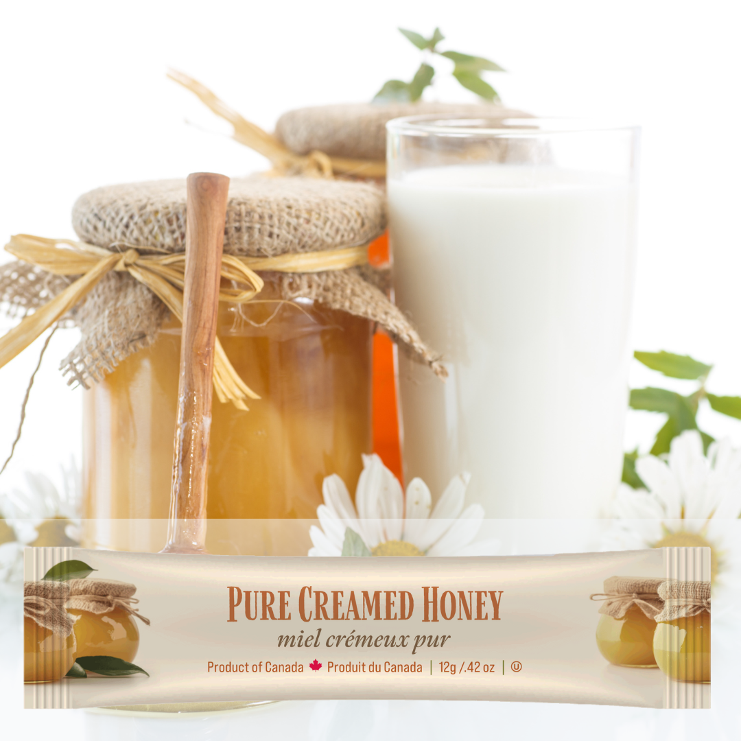 Jar of honey, glass of milk, package of Tu-Bees pure creamed honey mini squeeze pack on a white background