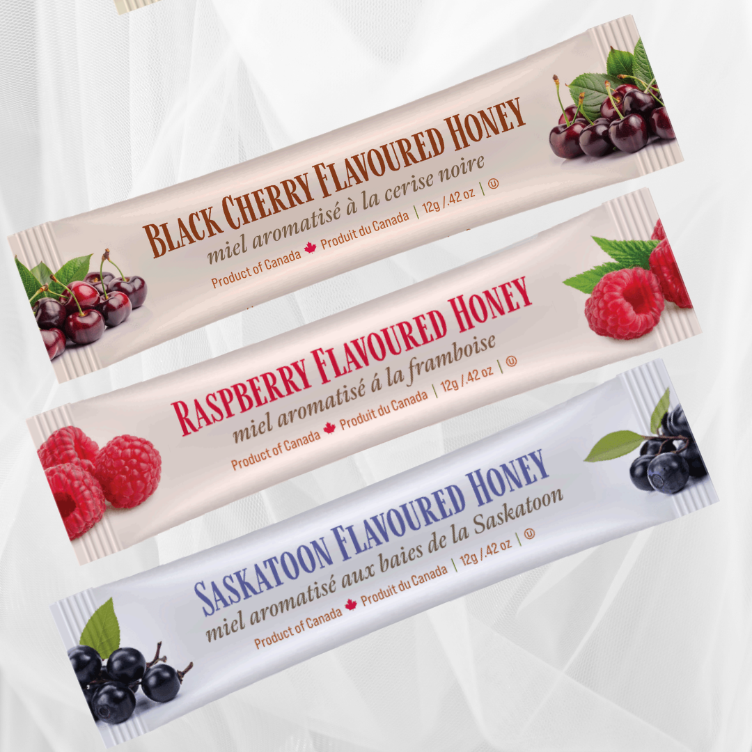 Three packages of Tu-Bees flavoured honeys in black cherry, raspberry, and saskatoon berry on a white background