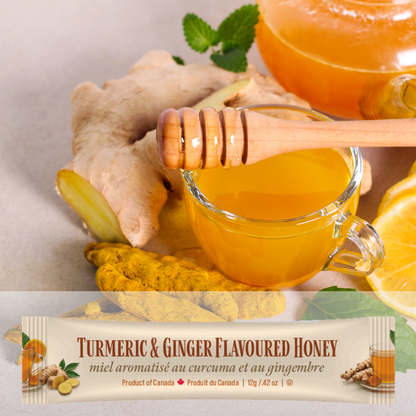 Turmeric & Ginger Flavoured Honey mini squeeze package with honey dipper, ginger root, and lemon.