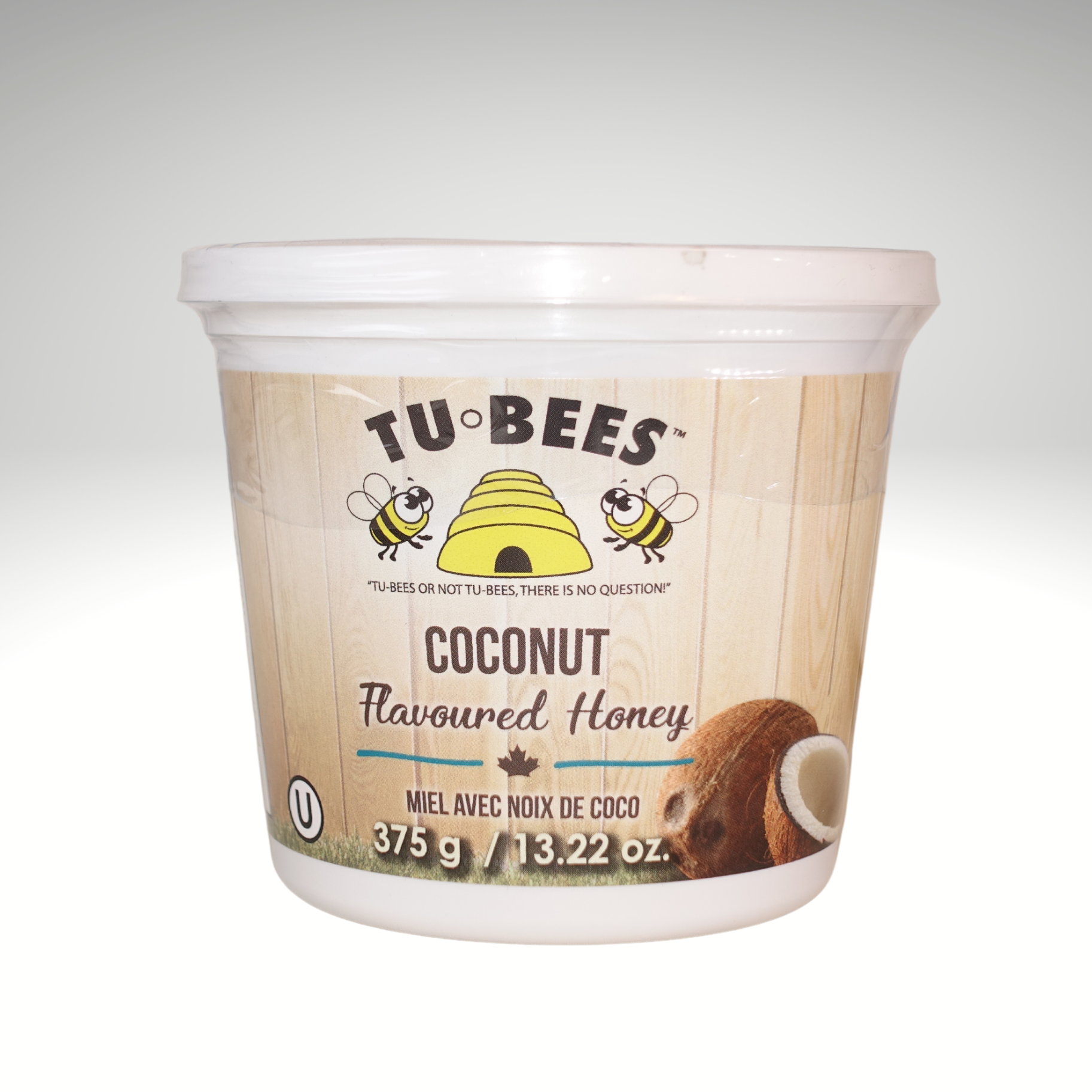 A 375g tub of Tu-Bees Coconut flavoured honey on a white background
