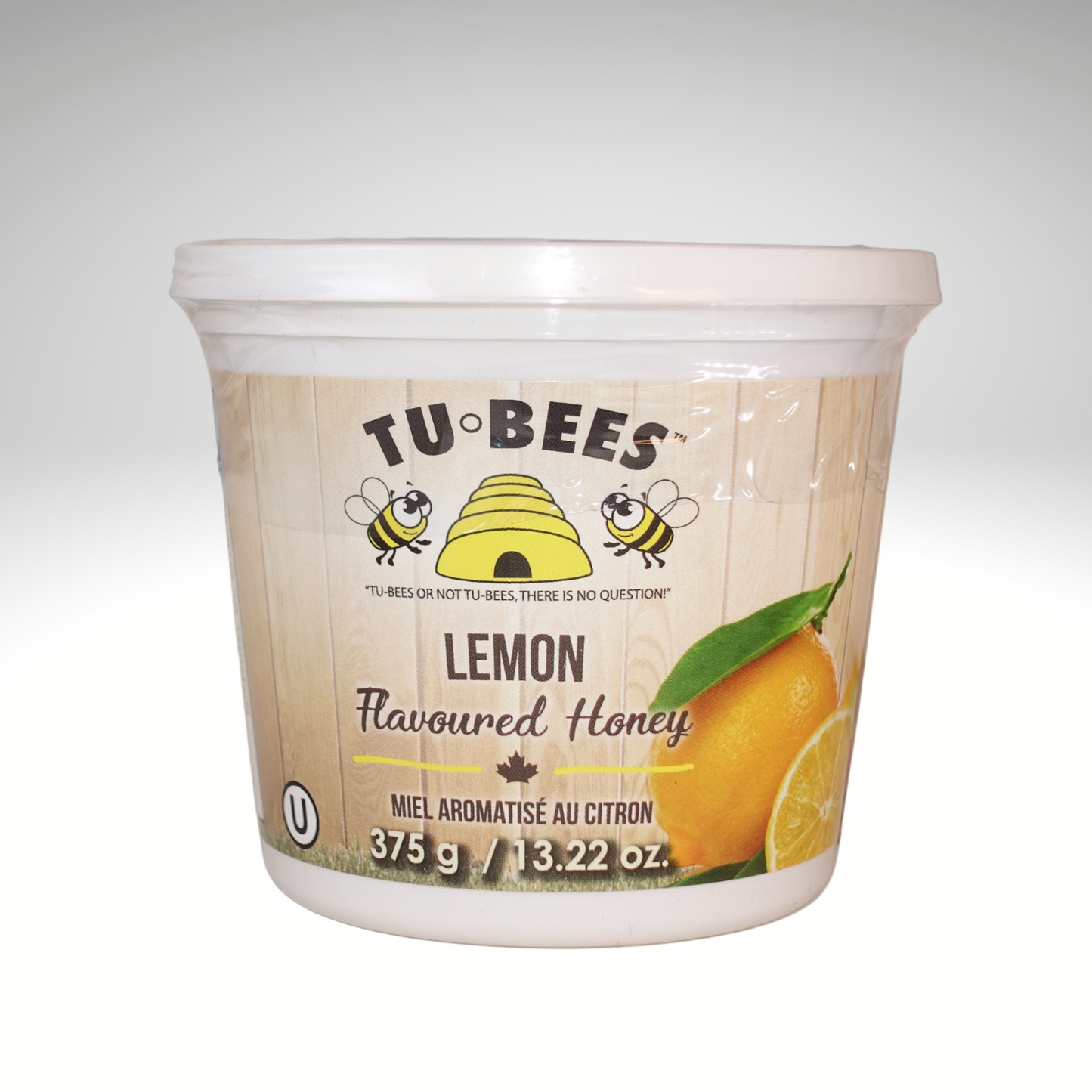 A 375g tub of Tu-Bees Lemon flavoured honey, OU Kosher, Product of Canada, on a white background