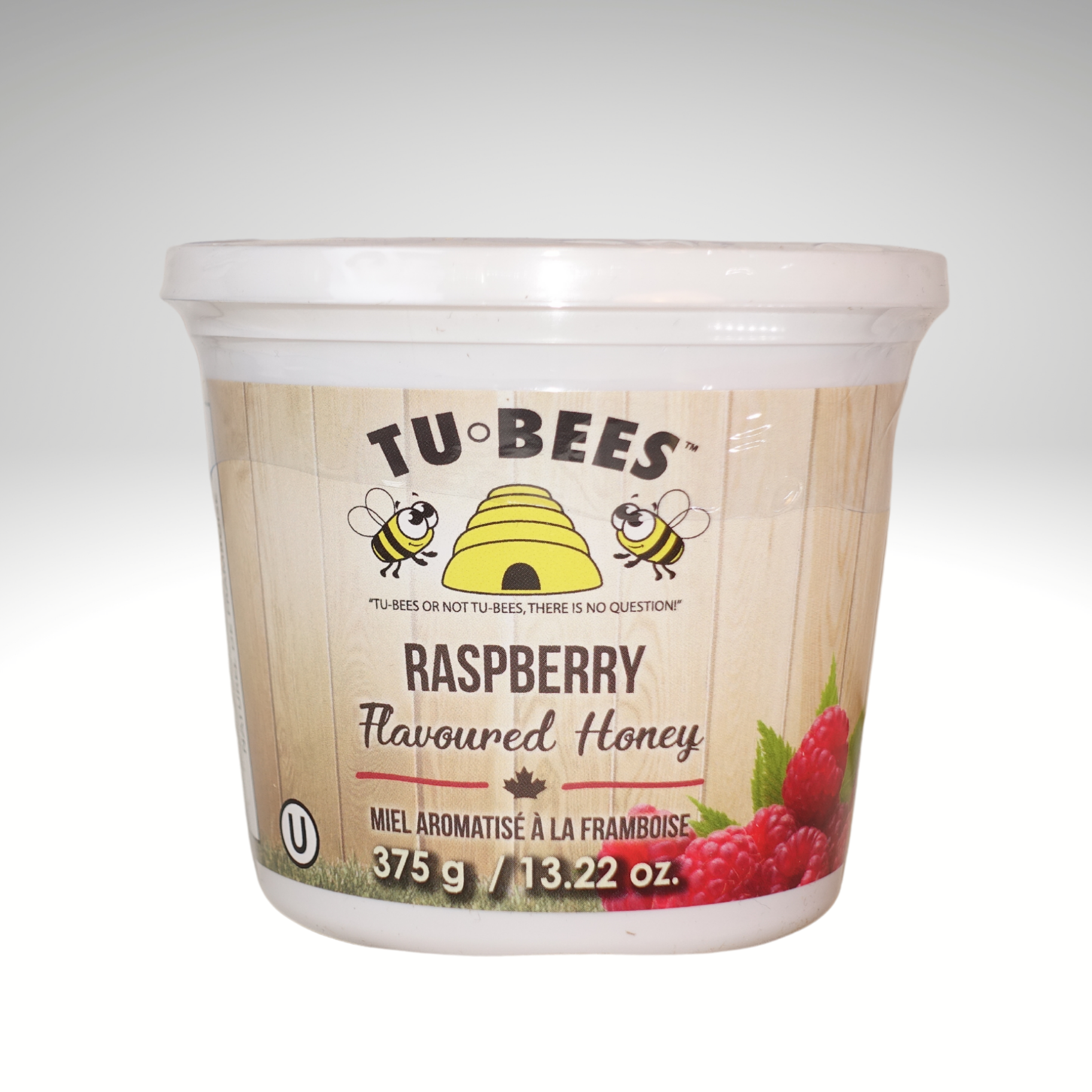 A 375g tub of Tu-Bees Raspberry flavoured honey, OU Kosher, Product of Canada on a white background