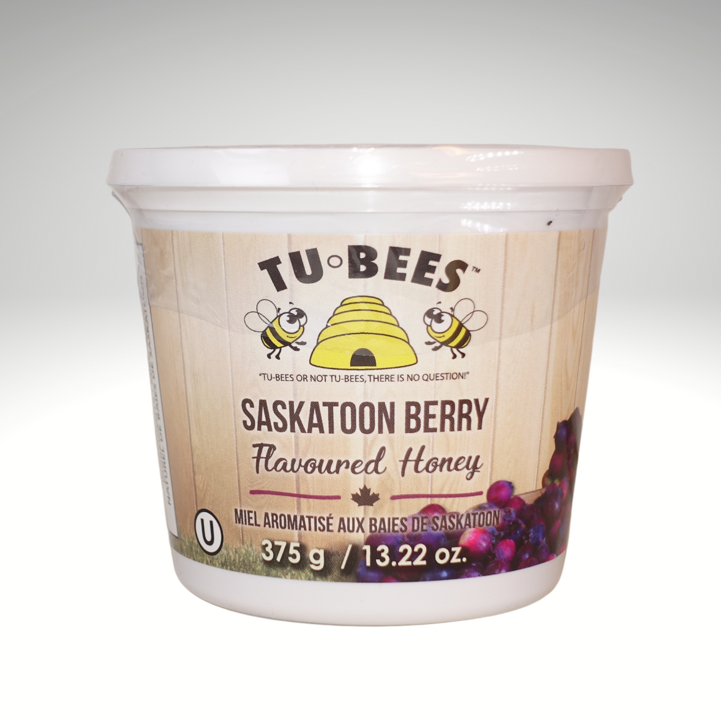 A 375g tub of Tu-Bees Saskatoon Berry flavoured honey, OU Kosher, Product of Canada on a white background