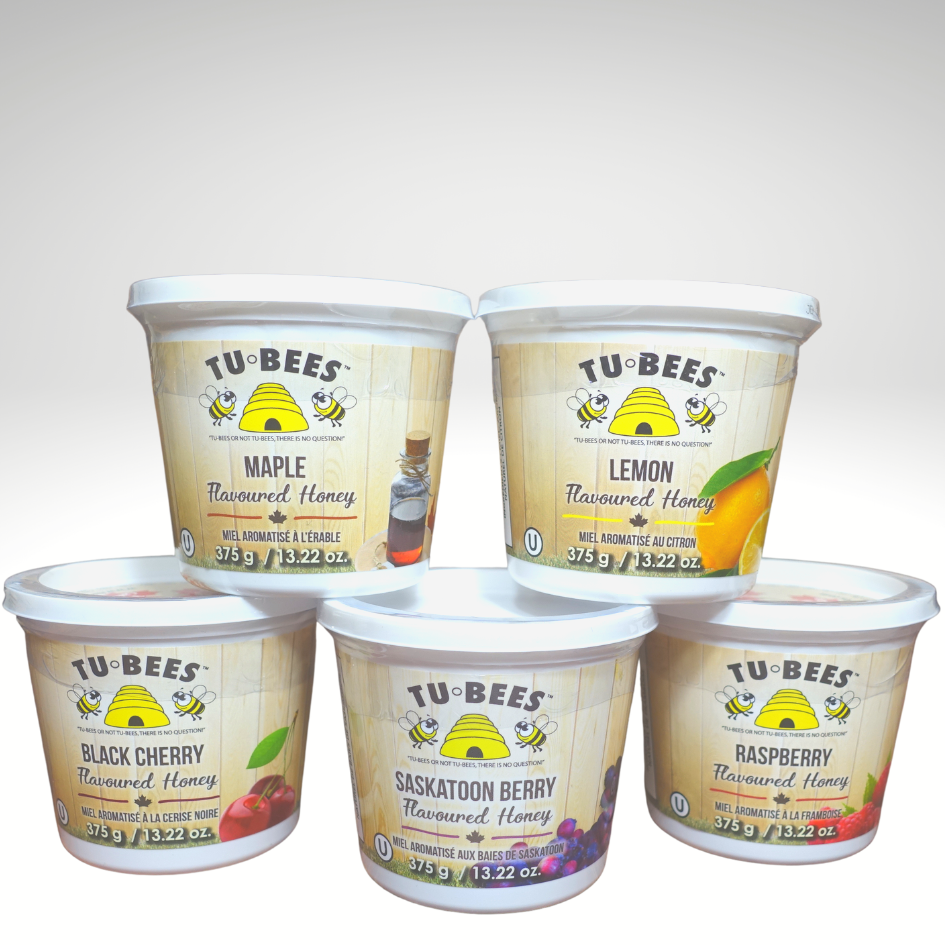 375g tubs of Tu-Bees  flavoured honey. Top row has Maple flavoured honey and Lemon flavoured honey. Bottom row has Black Cherry flavoured honey, Saskatoon Berry honey, and Raspberry flavoured honey.